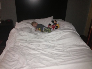 Sleeping in the hotel.  There's the pillow barrier to keep him from rolling off, then Micky and Minnie, then Baby Boy, then the tiny sliver of bed I slept in.